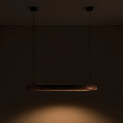 Handcrafted rosewood Scandinavian linear pendant light glowing warm amber — NixWoods