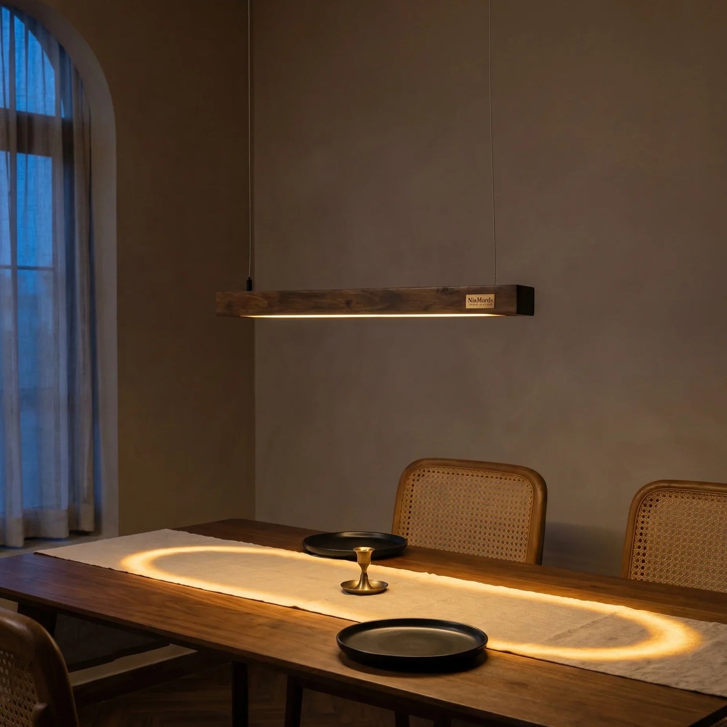 Rosewood linear pendant light over a styled dining table in a warm modern Indian home — NixWoods