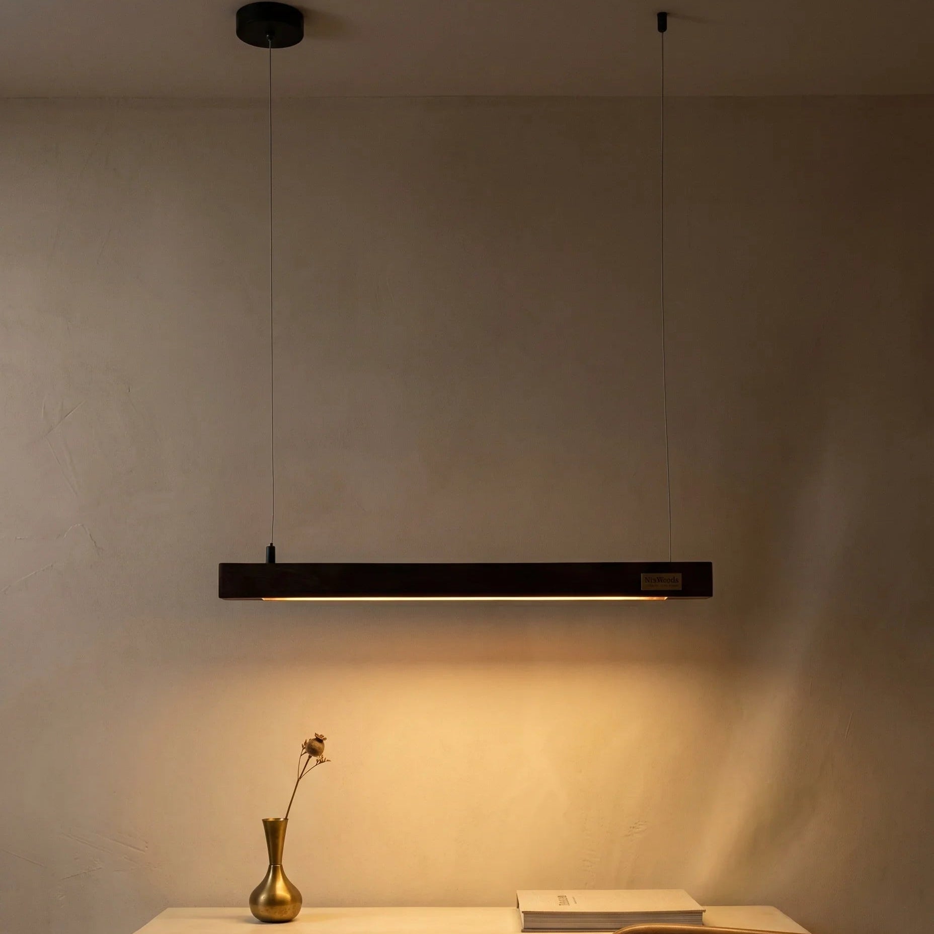 Rosewood linear pendant light in a warm modern living space — handcrafted by NixWoods