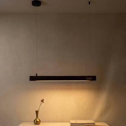 Rosewood linear pendant light in a warm modern living space — handcrafted by NixWoods