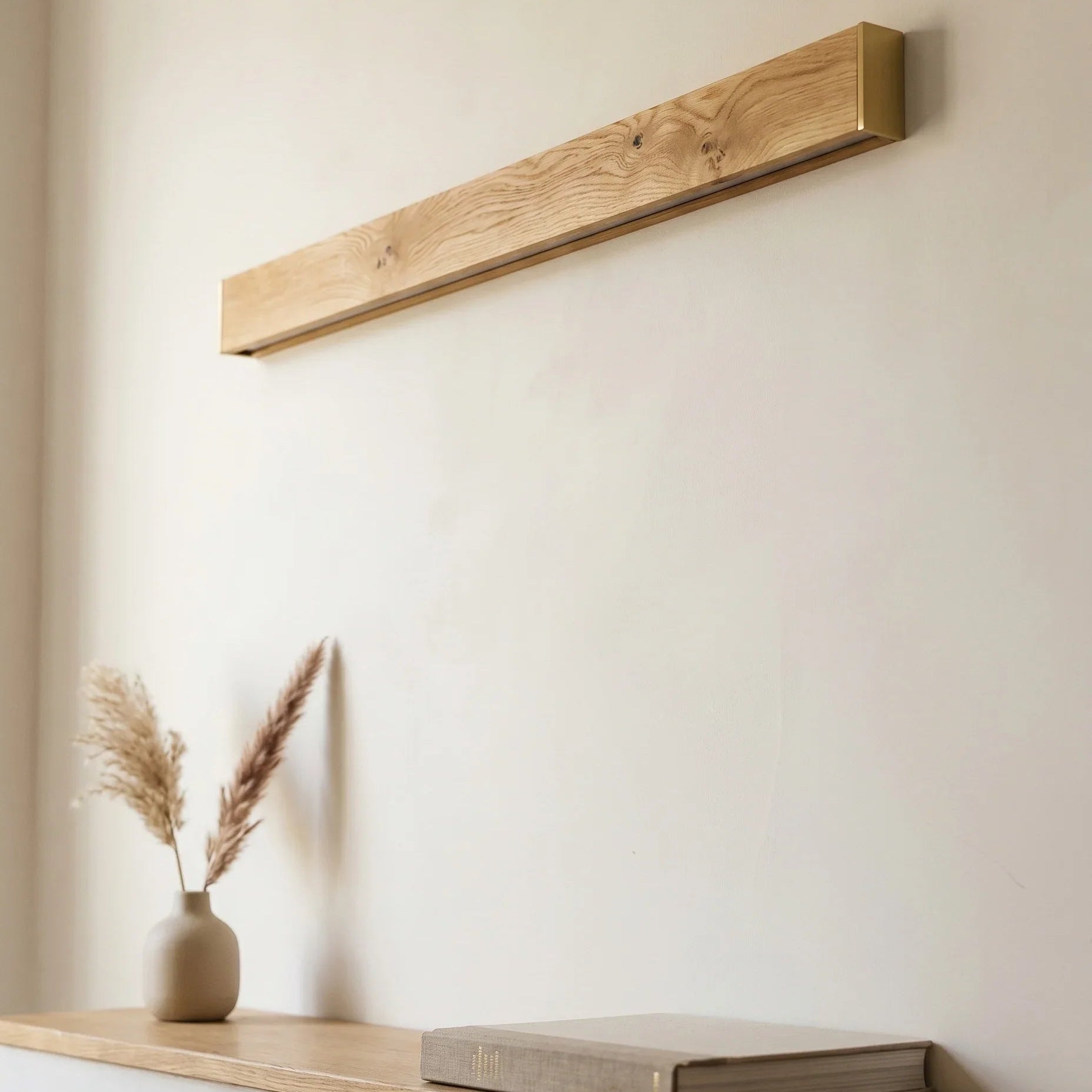 Nix Line solid wood wall light unlit by day, a sculptural wooden panel showing natural grain — NixWoods