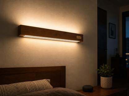 Duo Glow Wooden Wall Light installed on a bedroom wall at night, glowing upward and downward